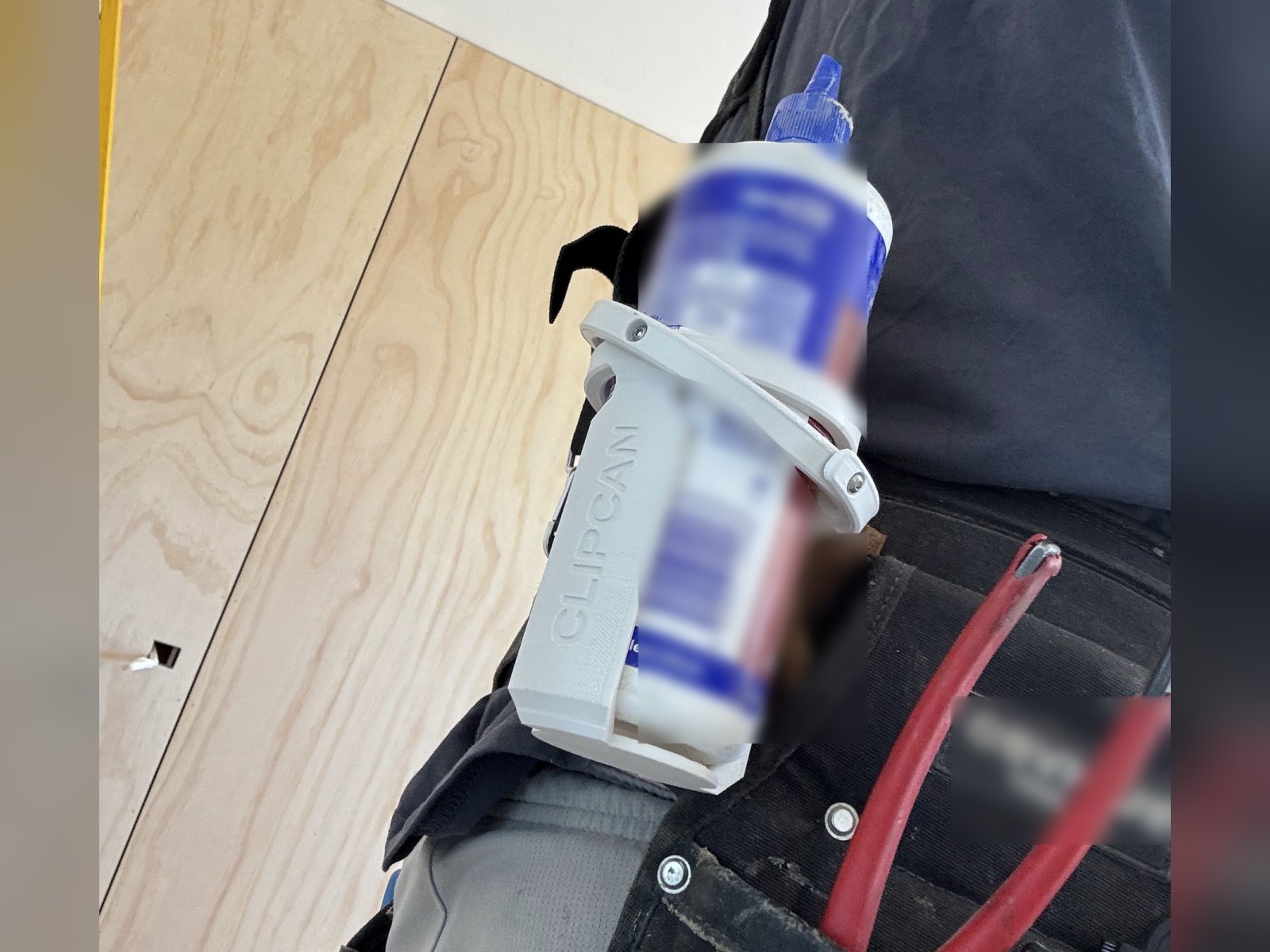 Clipcan Tool Belt holding a glue bottle on a builder’s tool belt
